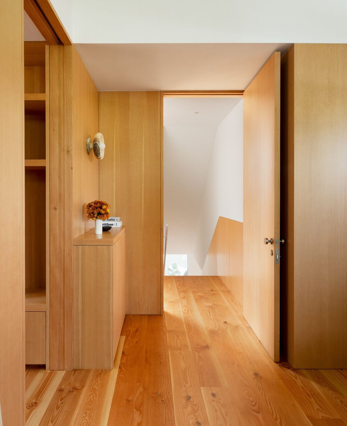 Altair: Fir-lined hallway with flush pocket doors and plank floors