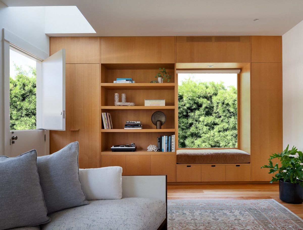 Altair: Fir wall of built-in shelving framing a garden window and window seat