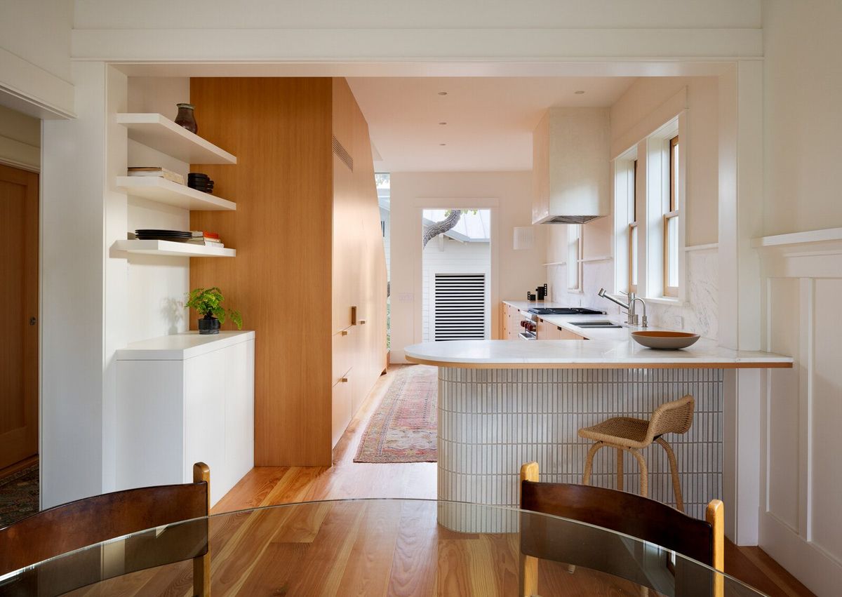 Altair: Kitchen with a curved tiled island, fir cabinetry and open shelves