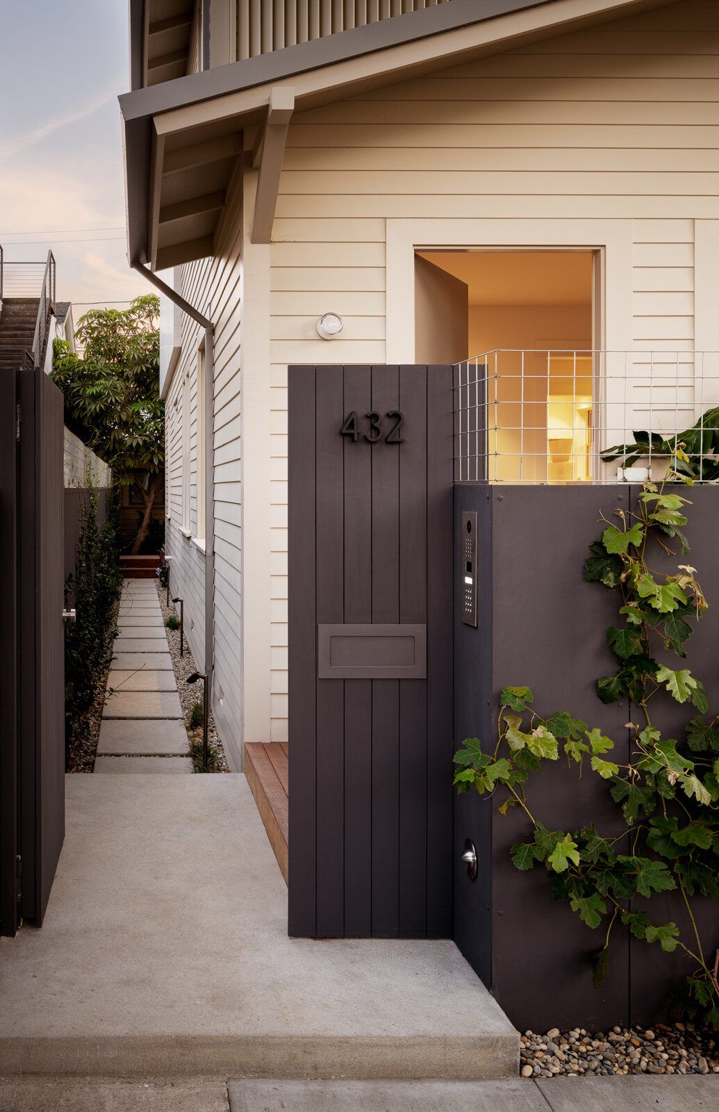 Altair: Side yard with a dark wood gate and white clapboard siding