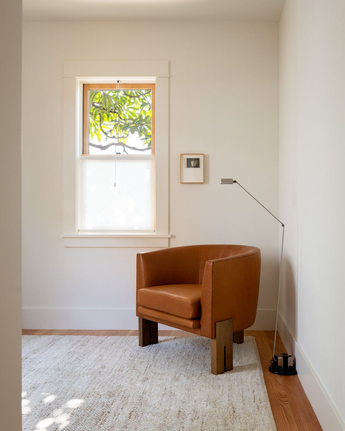 Altair: Reading corner with a leather armchair beneath a double-hung window
