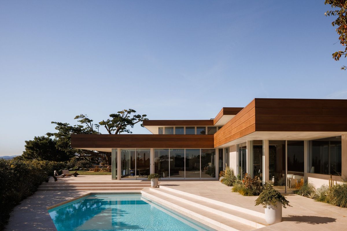 Carla Ridge: Mid-century modern hillside house with deep redwood eaves above the pool