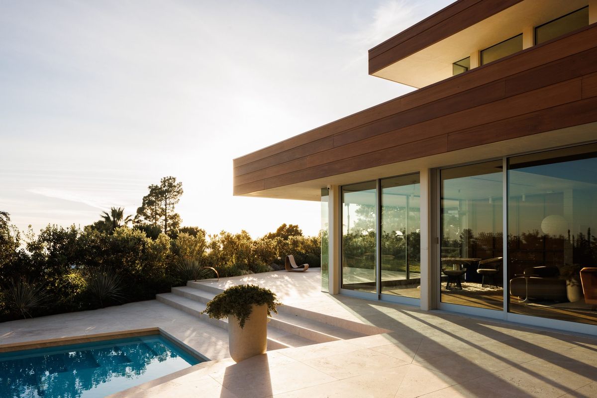 Carla Ridge: Pool terrace and sliding glass walls under a deep redwood overhang