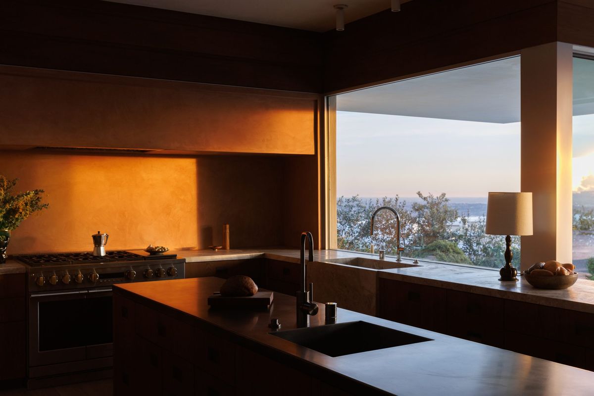 Carla Ridge: Kitchen at sunset with a window framing the city view