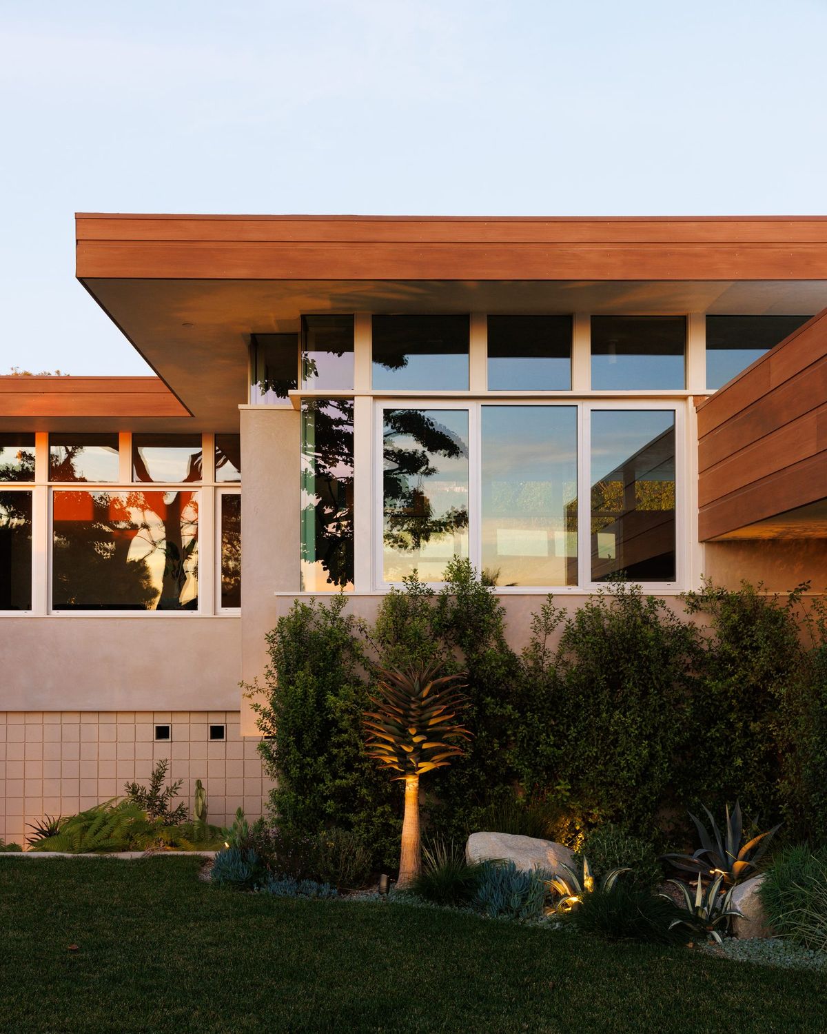 Carla Ridge: Redwood-clad facade and native planting at dusk