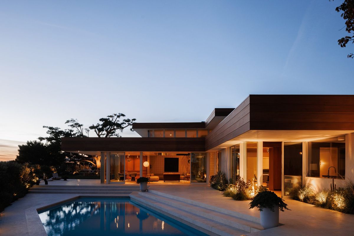 Carla Ridge: Pool terrace and glass walls lit at twilight