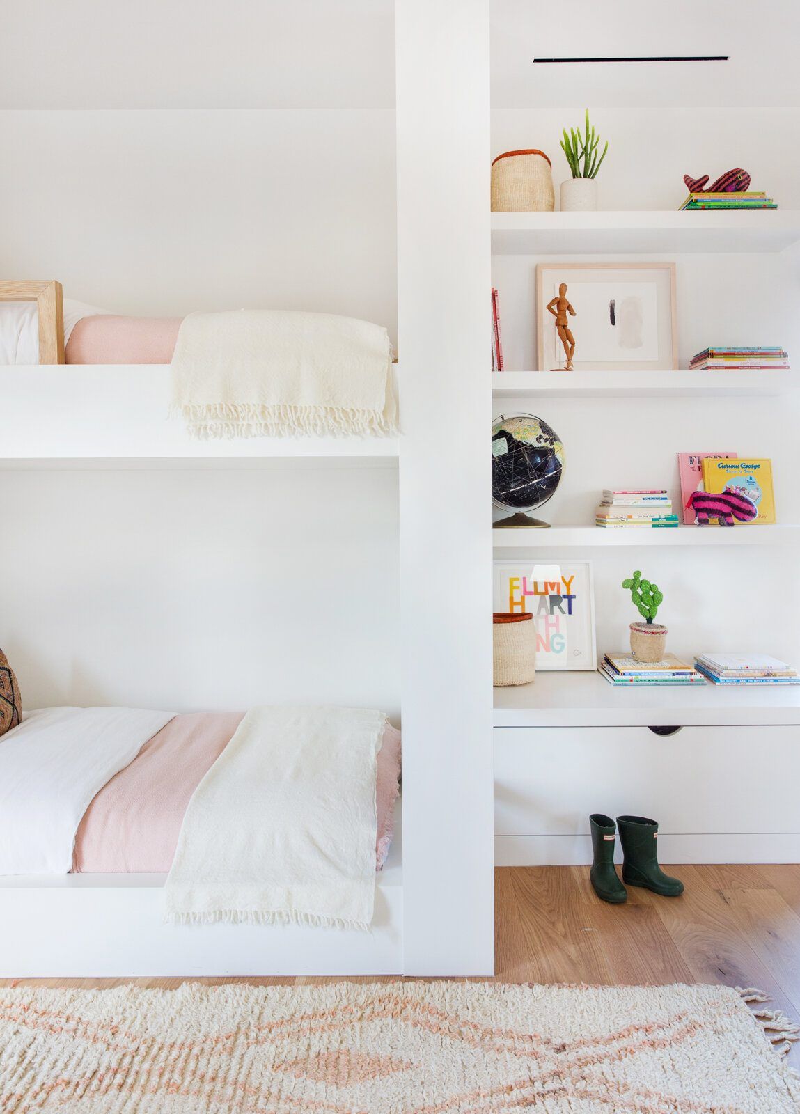 Flower: White bunk-bed nook with a pink blanket and shelving