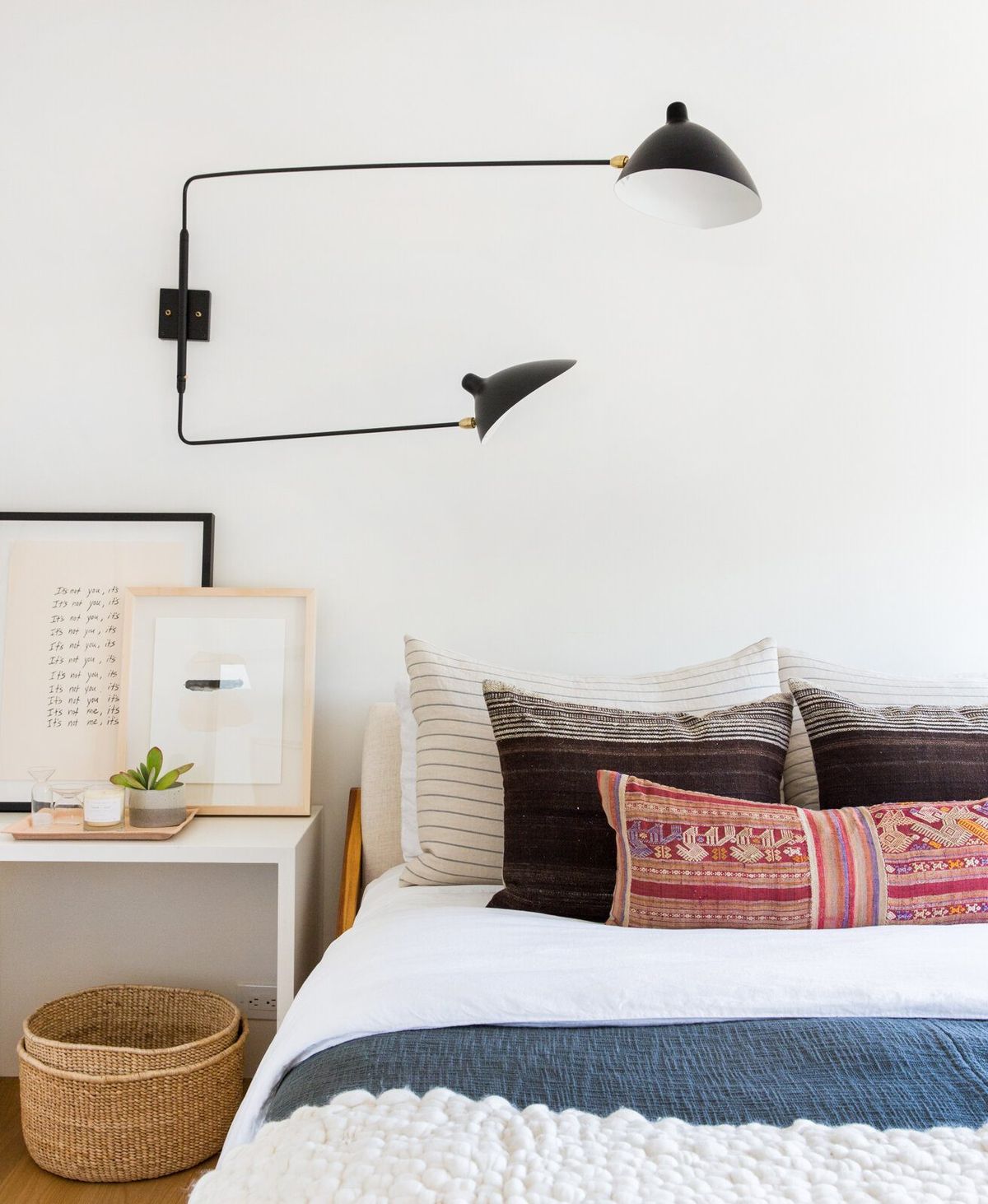 Flower: Bedside with a black wall sconce and patterned pillows