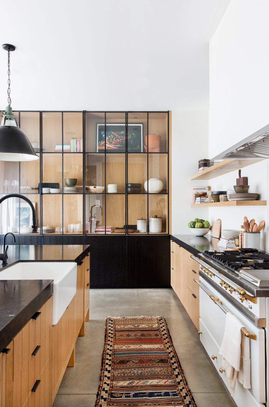 Flower: Galley kitchen with a farmhouse sink, runner rug and steel-framed cabinet