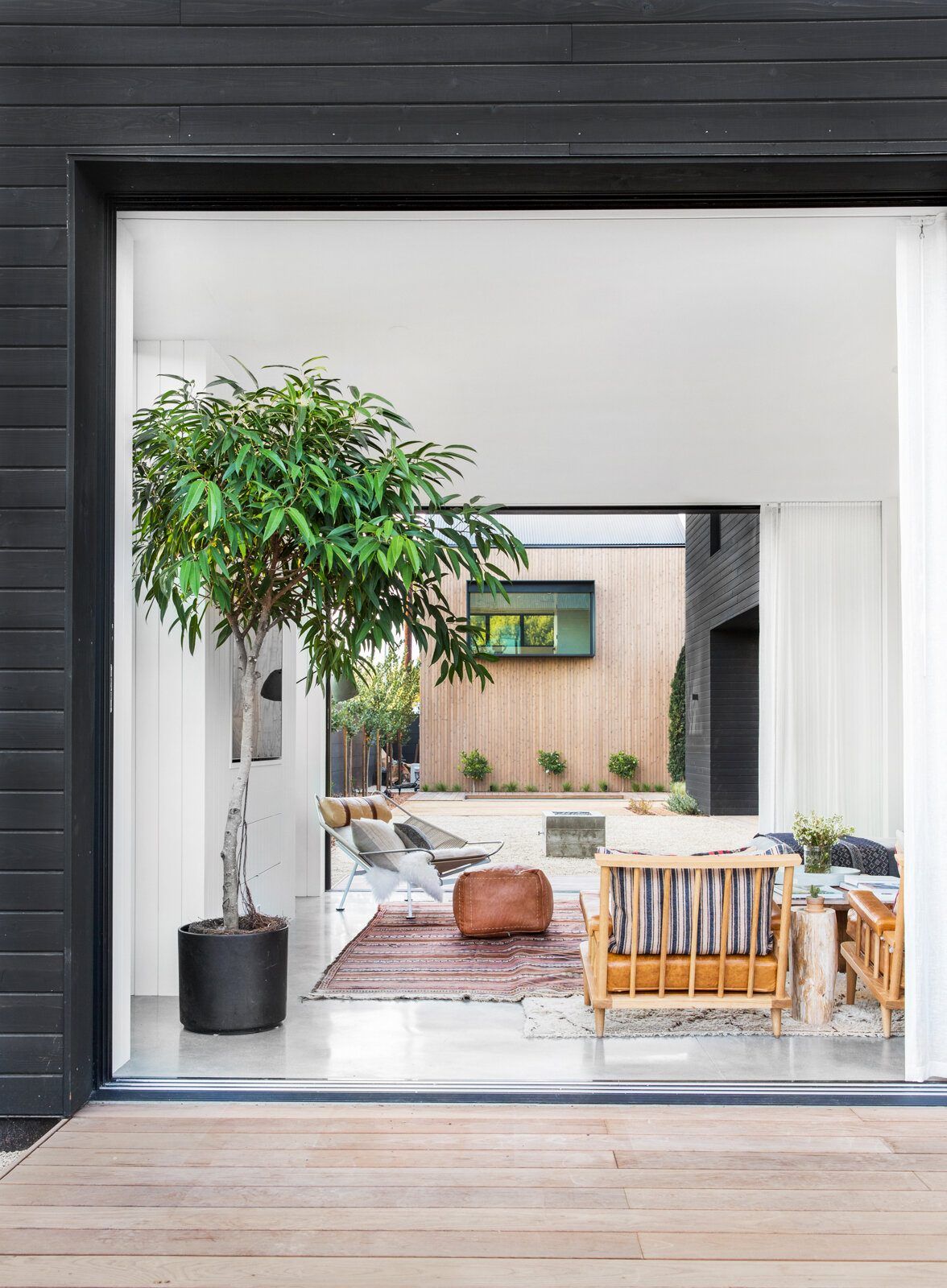 Flower: Black-framed opening looking into a bright sitting area