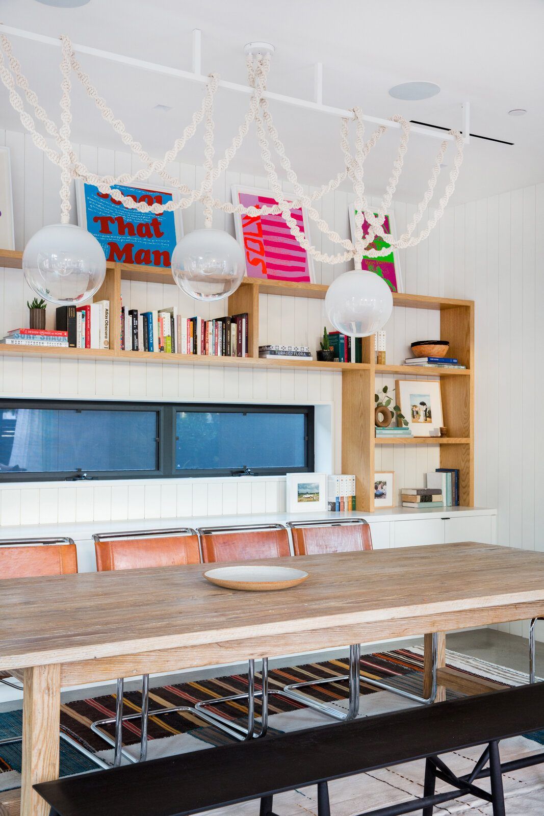 Flower: Dining table with bookshelves and a white rope pendant light