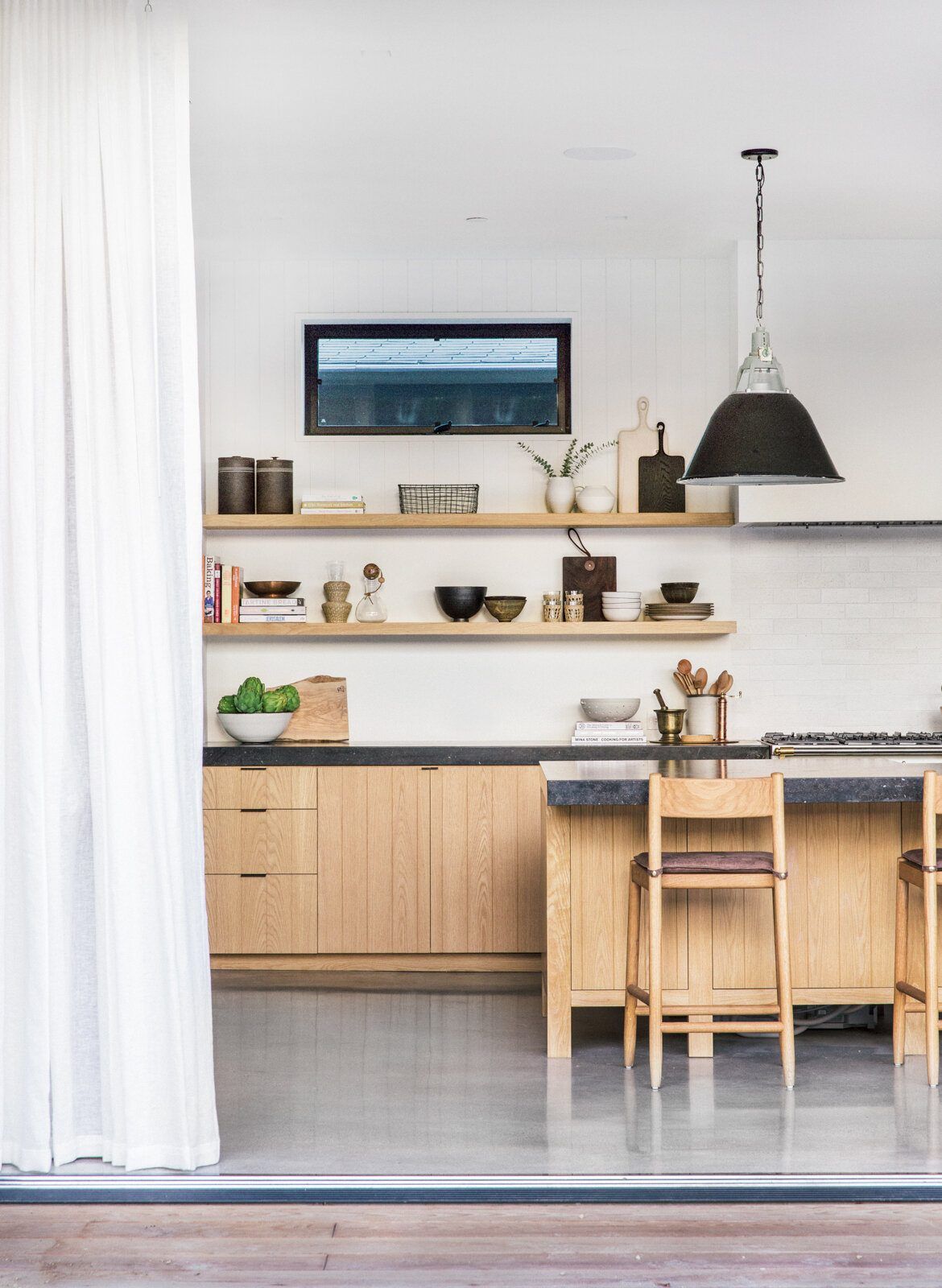 Flower: Kitchen with open shelves and oak island stools beside sheer curtains
