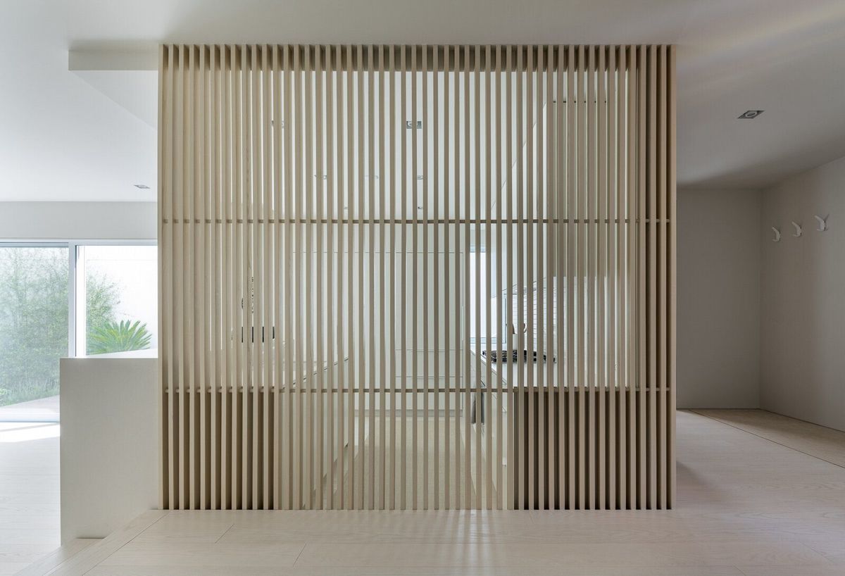Harbor: Oak slat screen partition in a pale open-plan room