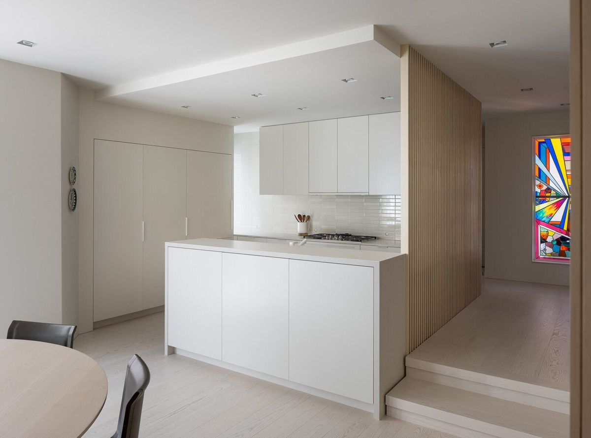 Harbor: White kitchen with an island and pale oak cabinetry