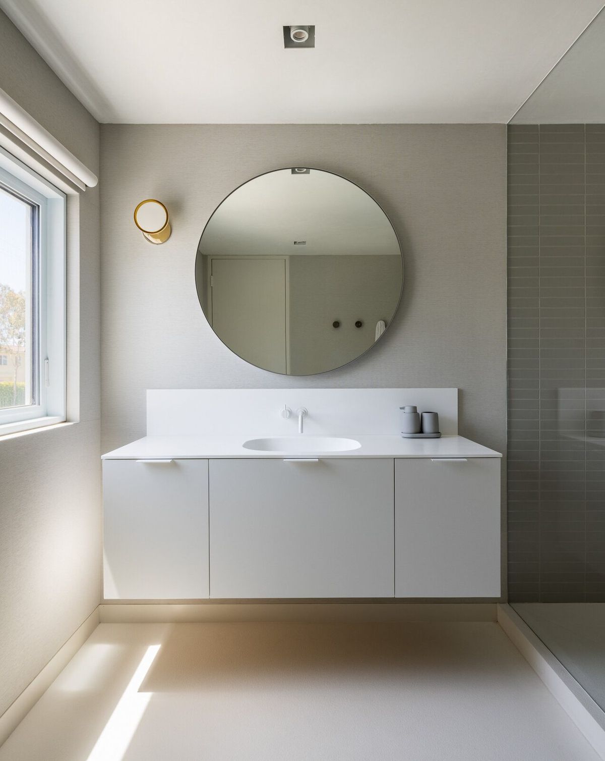 Harbor: Bath with a white floating vanity and round mirror