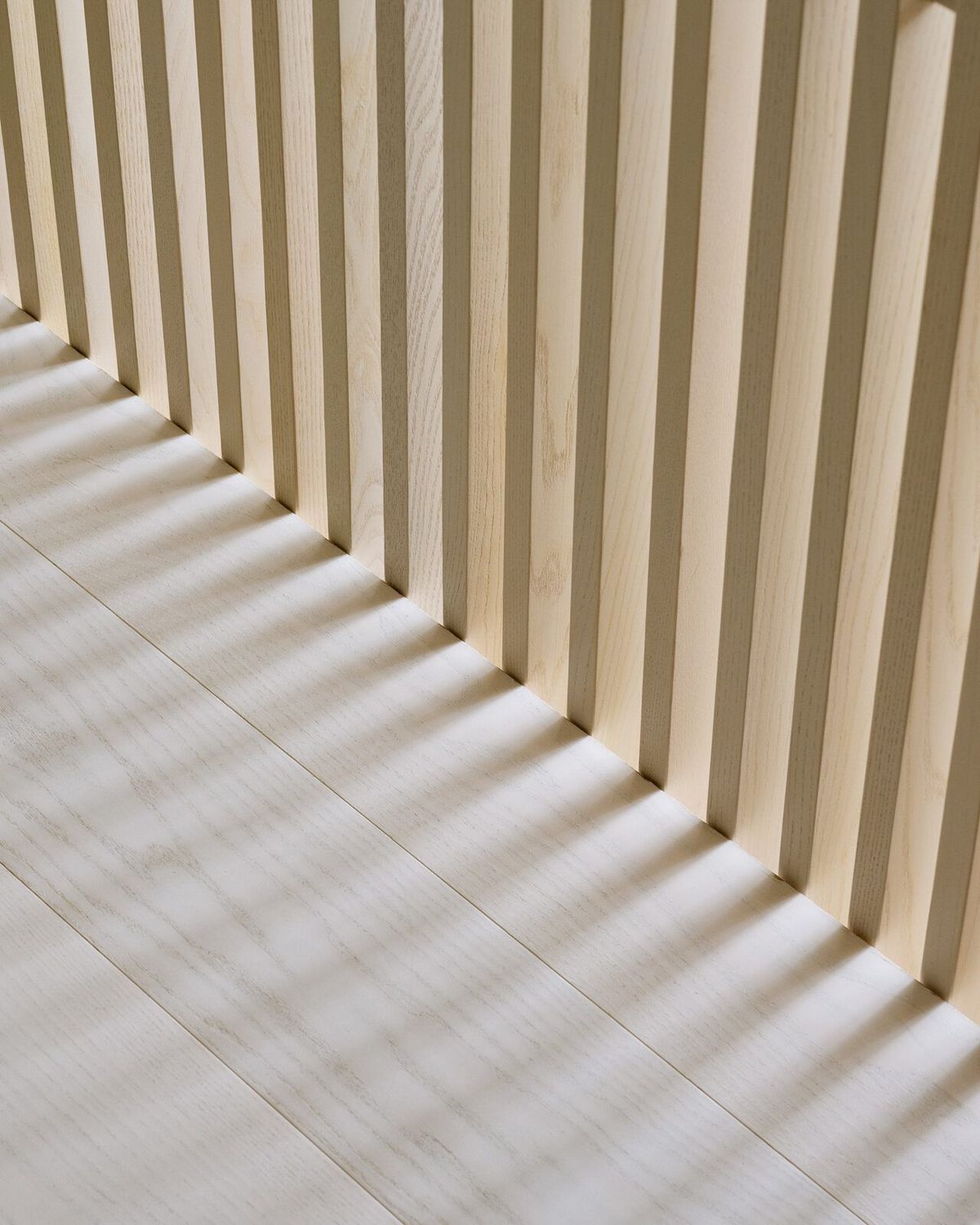Harbor: Sunlight through vertical oak slats onto a pale floor
