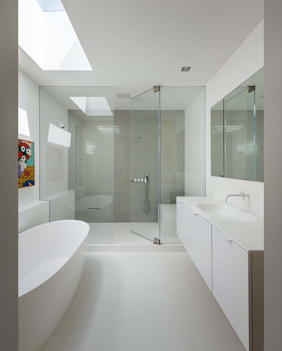 Harbor: Primary bath with a freestanding tub and glass shower under skylights