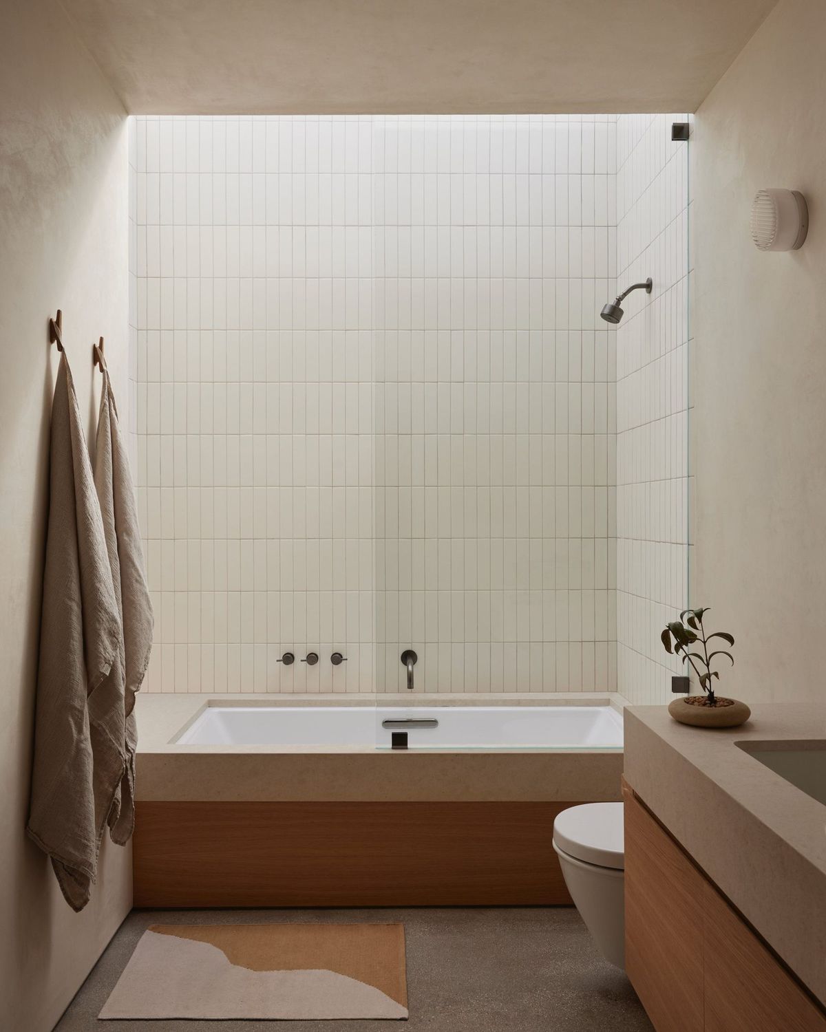 Meier: Bath with a tiled tub alcove and wood vanity