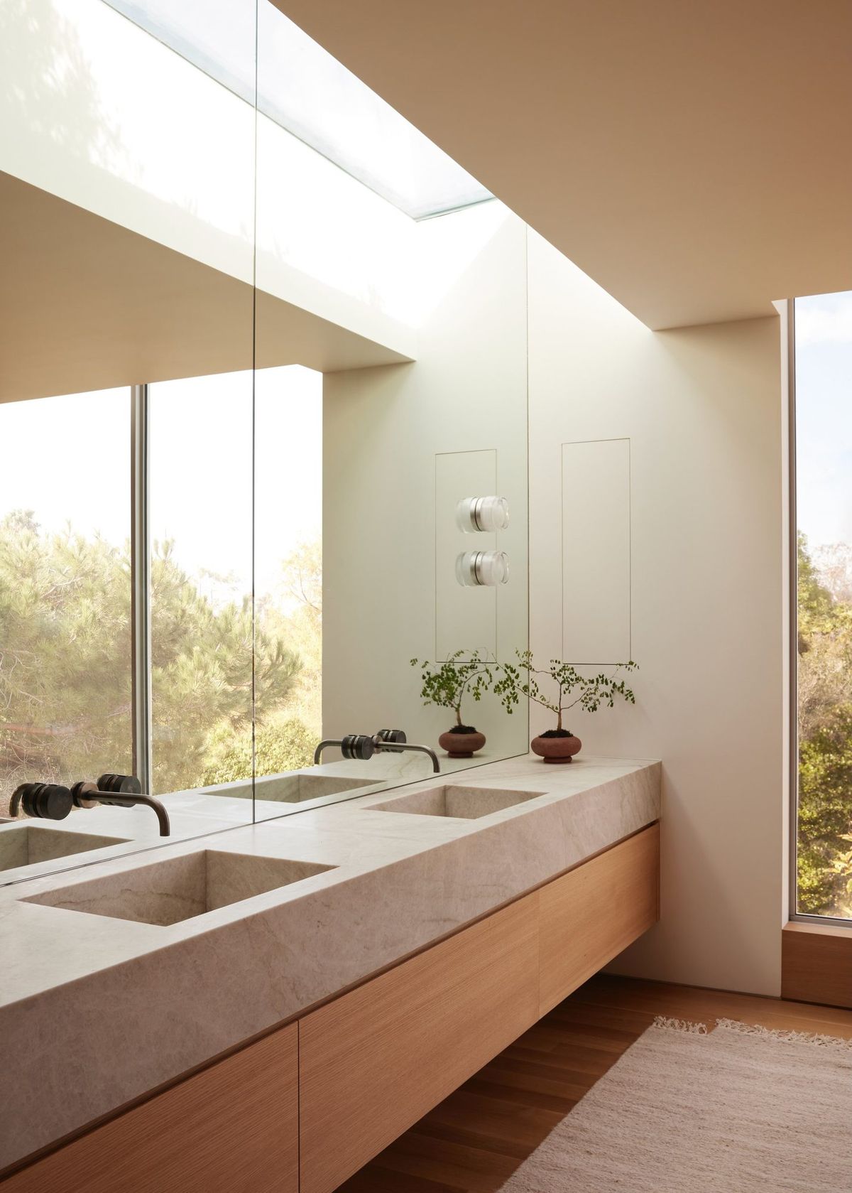 Meier: Skylit bath with a stone double vanity and garden window
