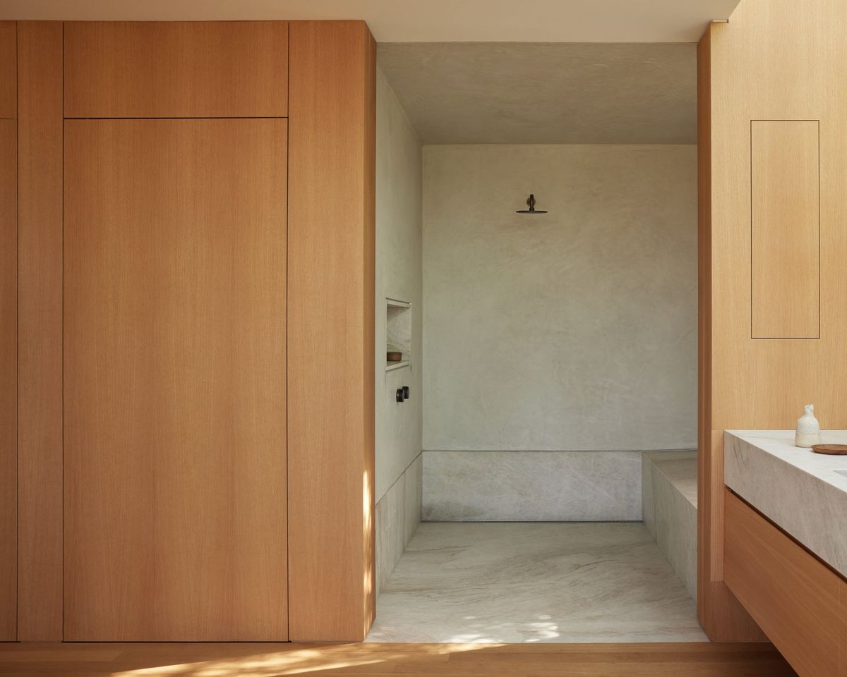 Meier: Wood-paneled walk-through to a plaster shower