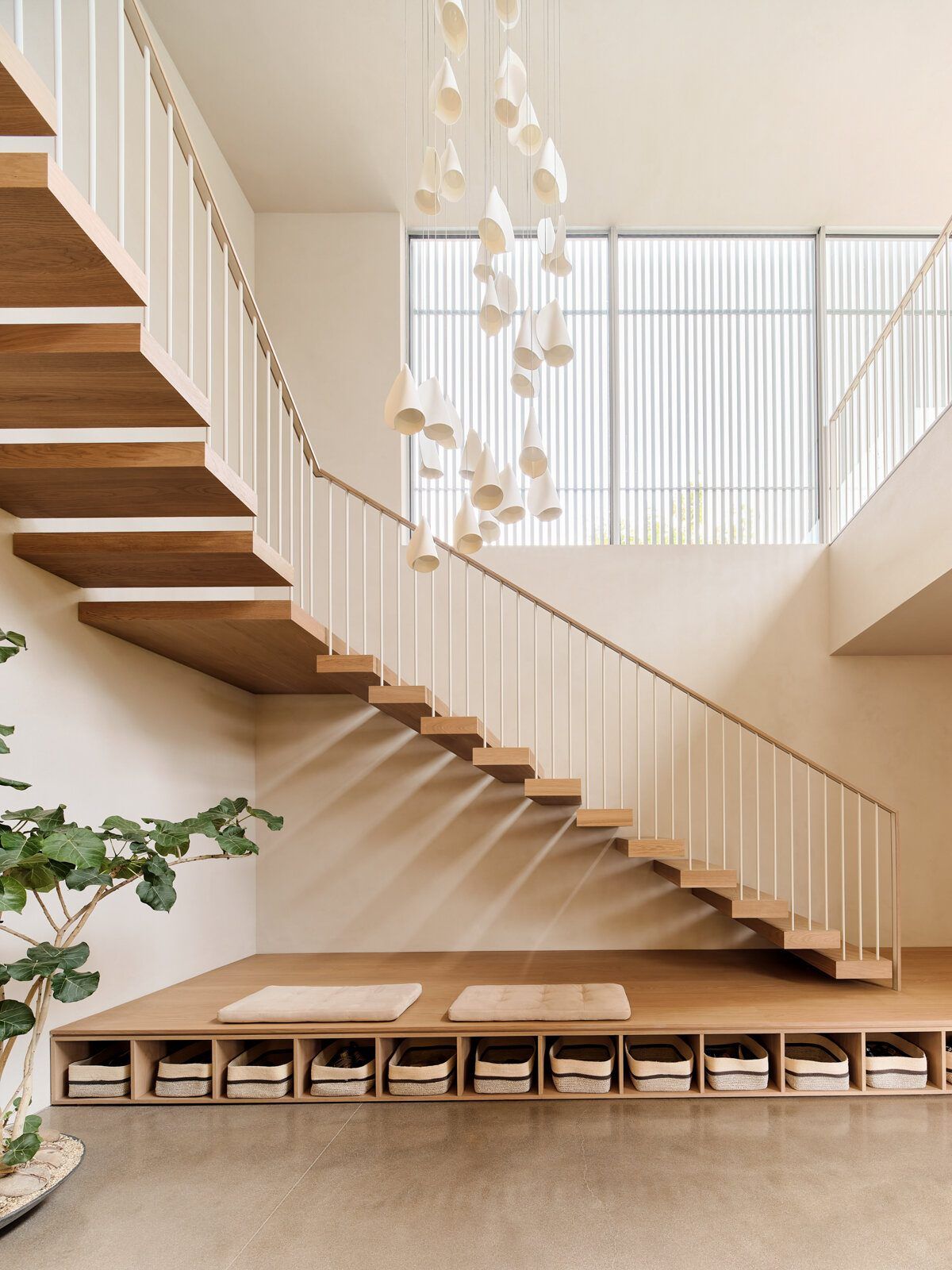 Modjeska: Floating timber stair beneath a cluster of glass pendant lights