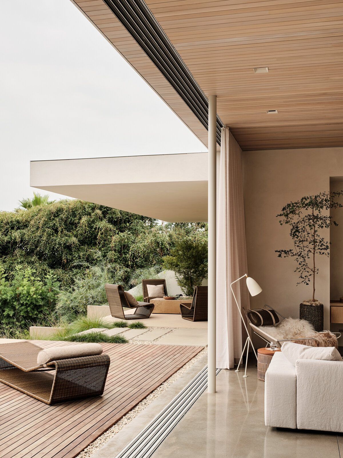 Modjeska: Terrace seen past a sliding glass wall and plaster overhang