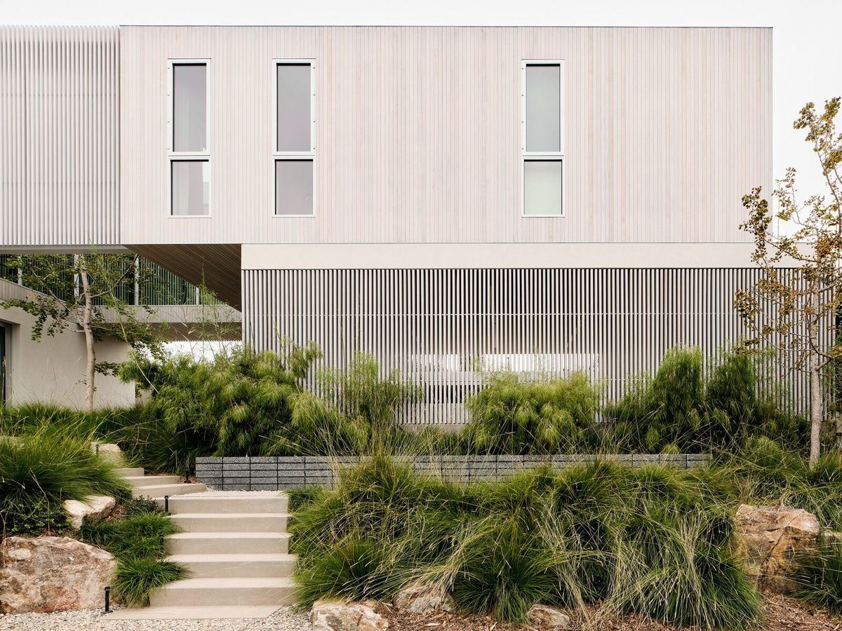 Modjeska: Pale plaster and cedar-louvered facade above a terraced native garden