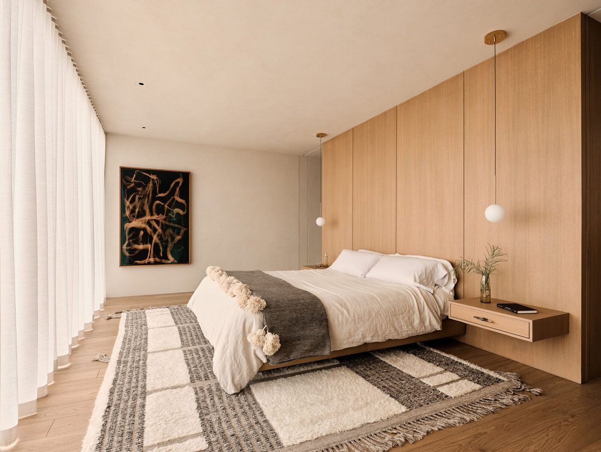 Modjeska: Primary bedroom with an oak headboard wall and textured rug