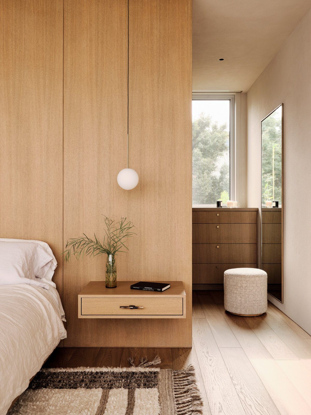 Modjeska: Floating oak nightstand and pendant light beside the bed