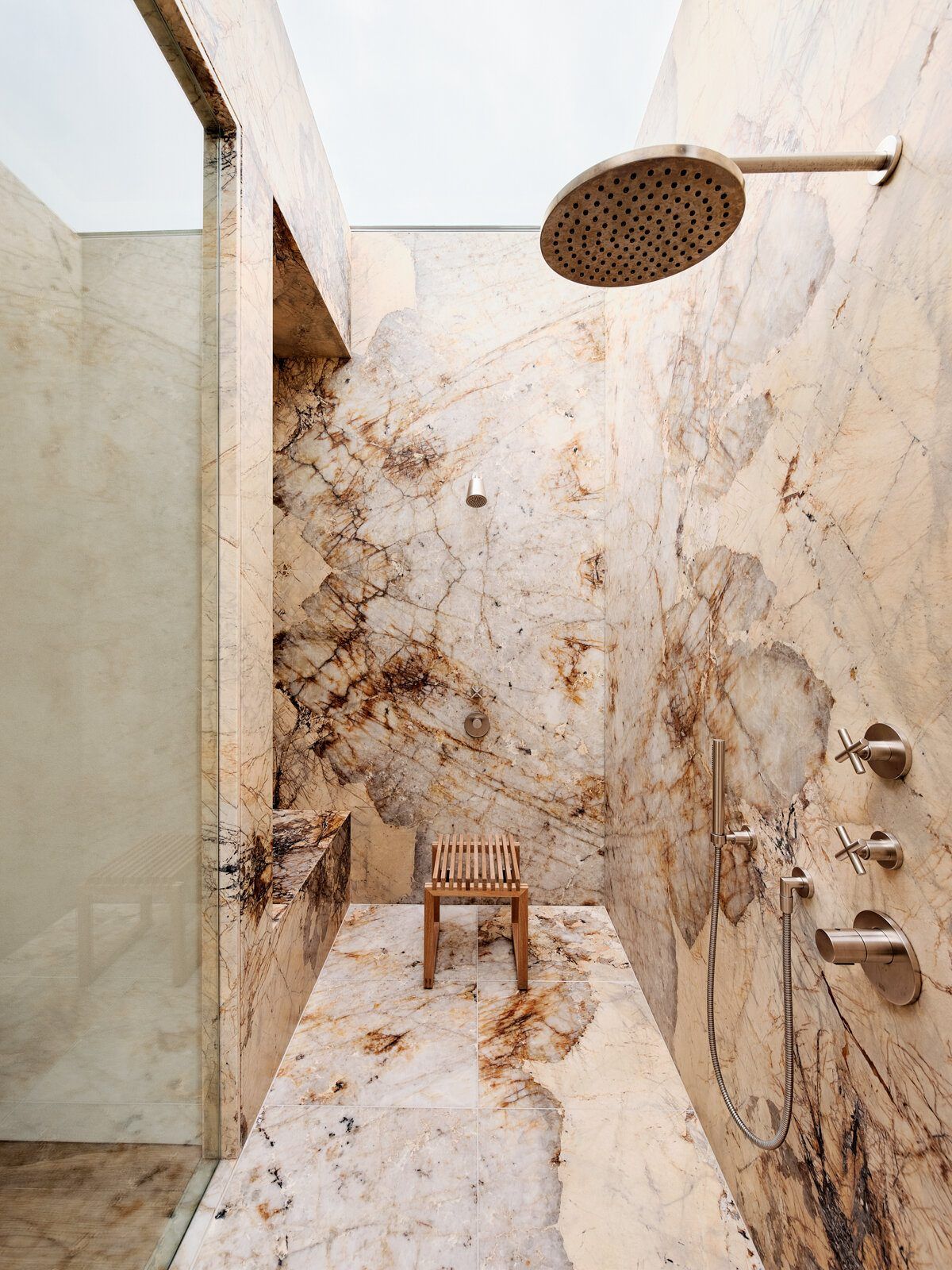 Modjeska: Marble-walled shower with a brass rain head