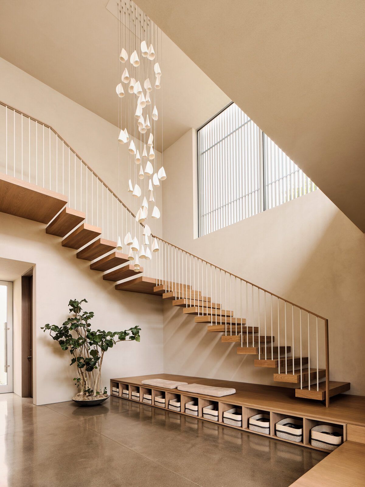 Modjeska: Double-height stair hall with floating timber treads and glass pendants