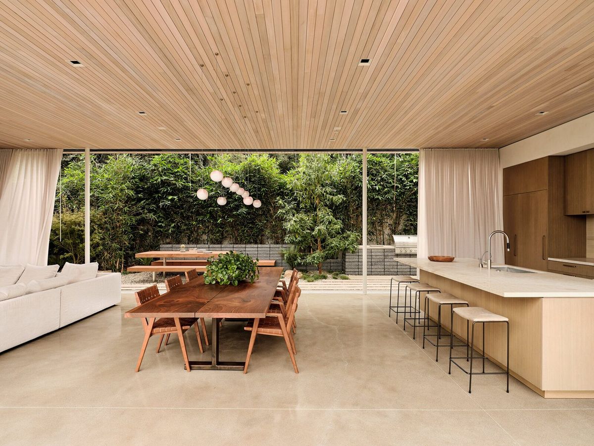 Modjeska: Open kitchen and dining room with a long wood table and garden view