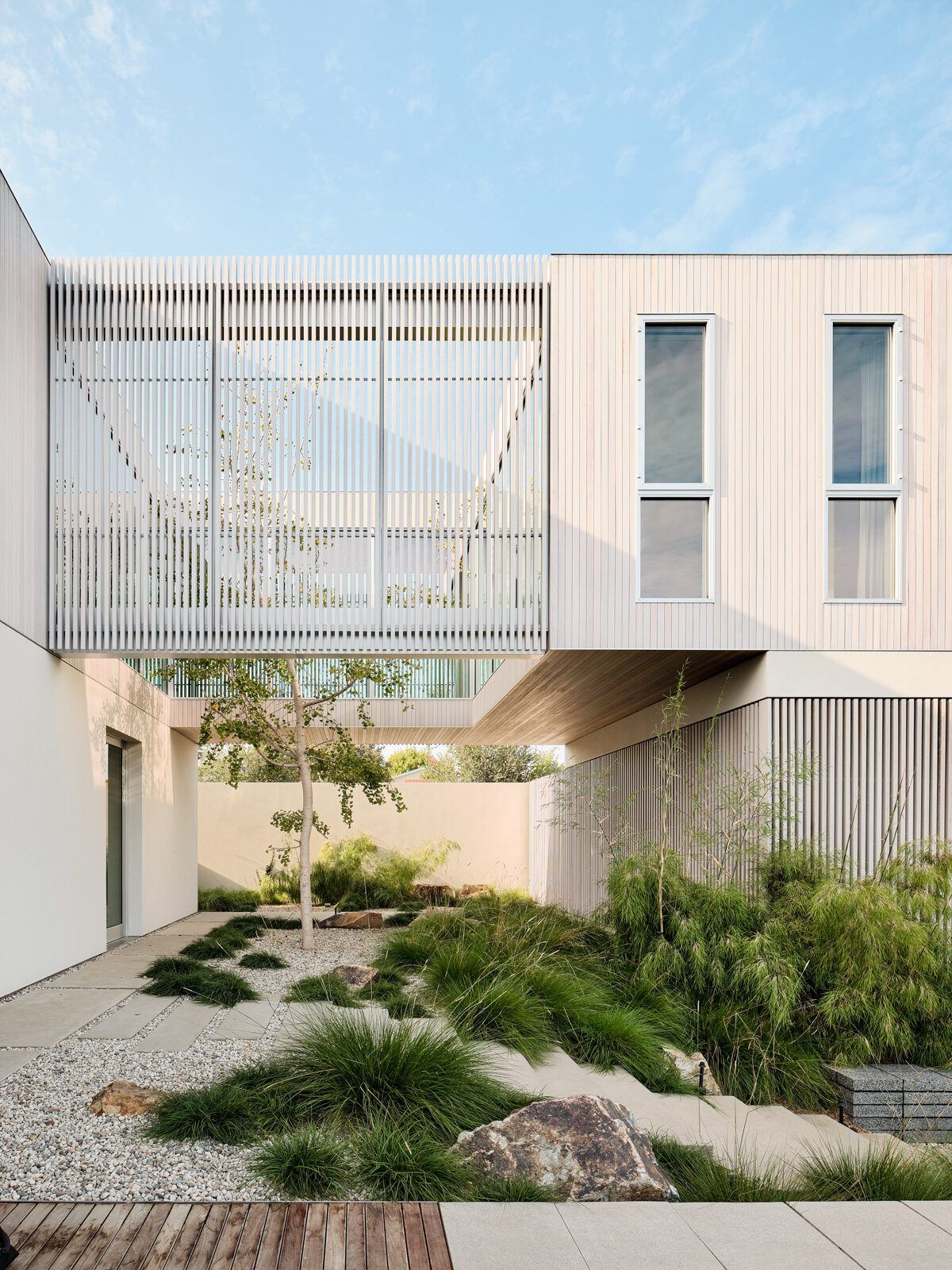 Modjeska: Courtyard garden under the louvered second-floor bridge
