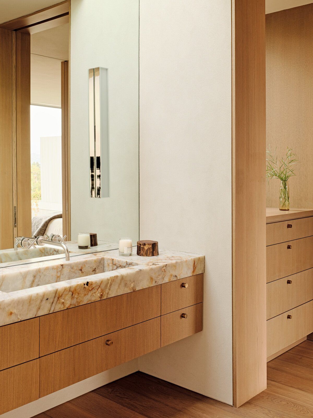 Modjeska: Oak vanity with a marble countertop beside a tall mirror