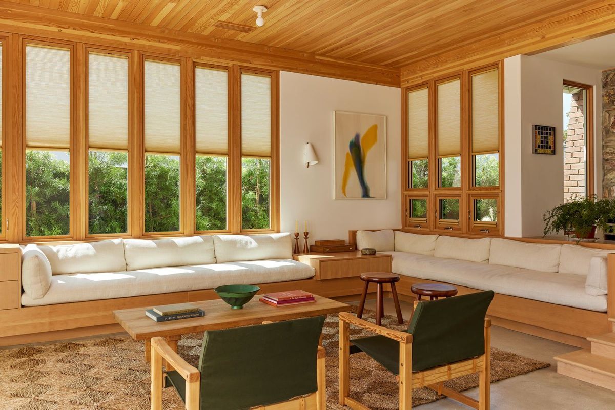 Stewart: Living room with wood ceiling, built-in sofa and banks of windows
