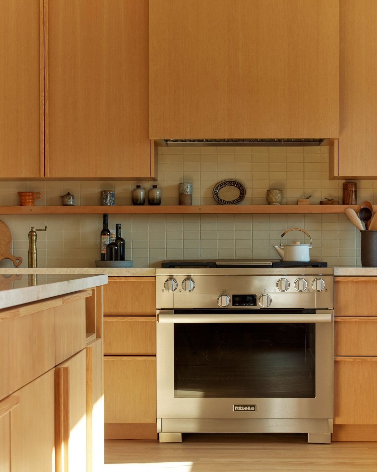 Stewart: Kitchen with fir cabinetry and a stainless range